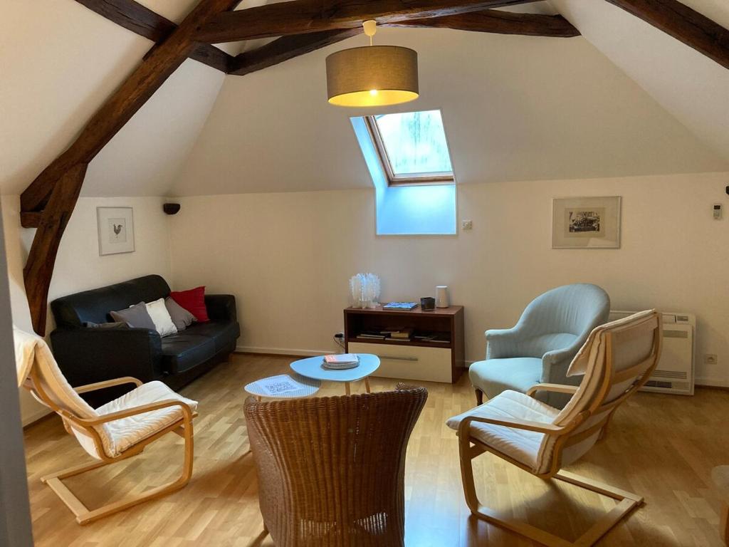- un salon avec un canapé, une table et des chaises dans l'établissement Appartement douillet, spacieux et convivial, à Vierzon