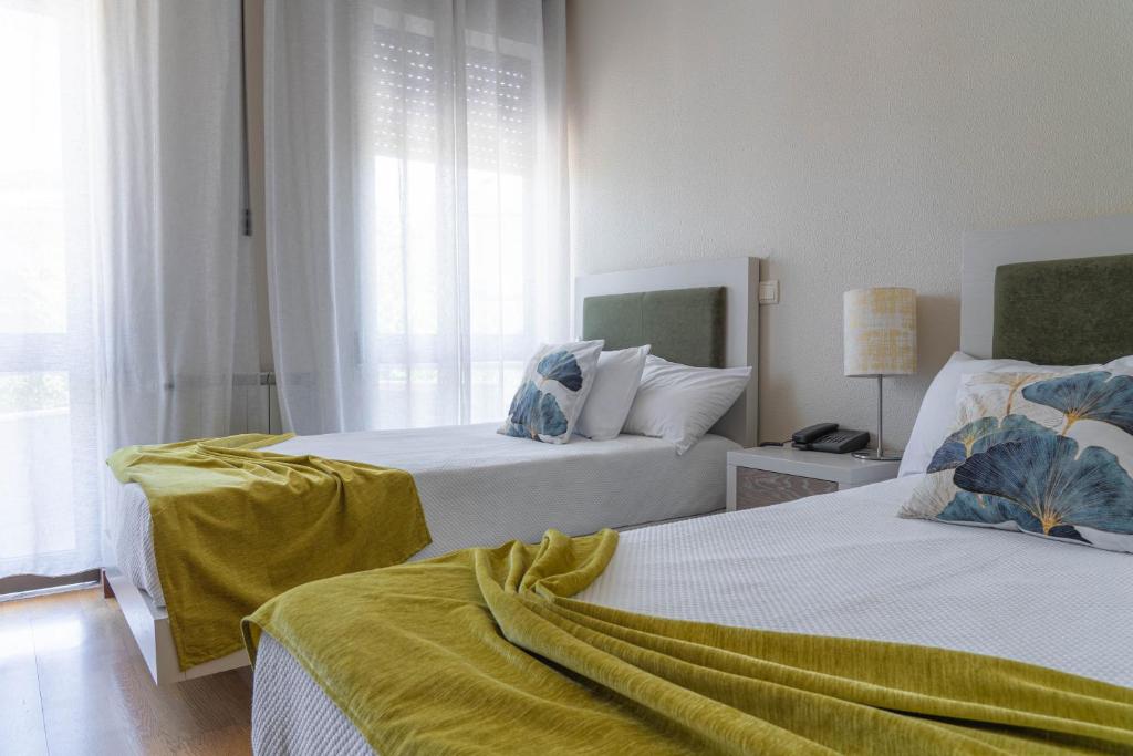 Postel nebo postele na pokoji v ubytování Residencial Clássico