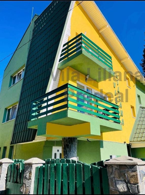 a colorful building with a balcony on the side of it at Vila Liliana in Predeal