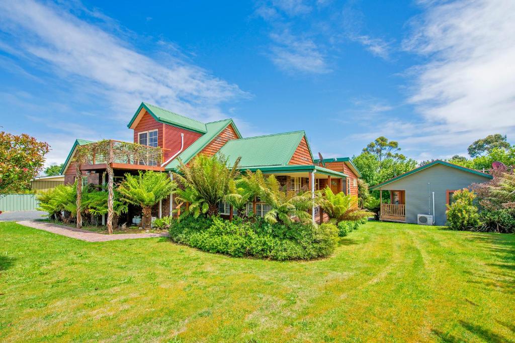 a house with a large garden and trees at Aloft Boutique Accommodation in Strahan