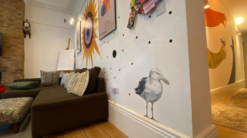 a living room with a bird on the wall at Church Retreat - A Magnificent Seaside Apartment-Award Winning in Hastings