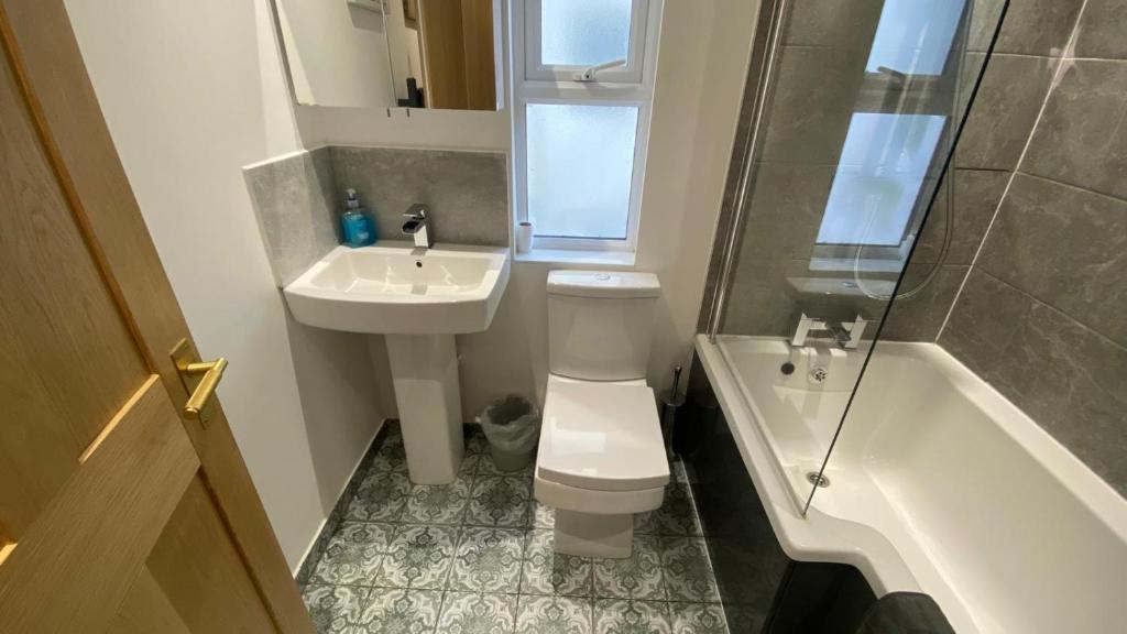 a bathroom with a toilet and a sink and a shower at Church Retreat - A Magnificent Seaside Apartment-Award Winning in Hastings