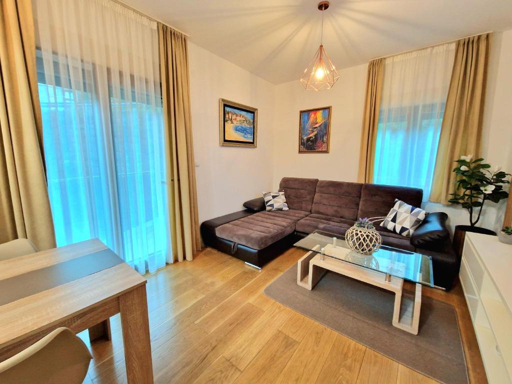a living room with a couch and a table at Apartman BJANKA in Budva
