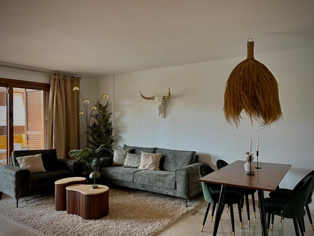 a living room with a couch and a table at Seaside Park Haven in Punta Prima