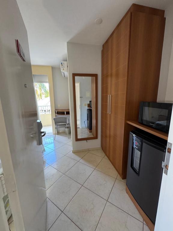 a kitchen with a door leading to a living room at Condomínio Residencial Thermas Place Apto 119 in Caldas Novas