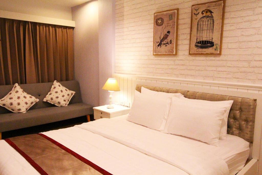 Postel nebo postele na pokoji v ubytování At Residence Suvarnabhumi Hotel