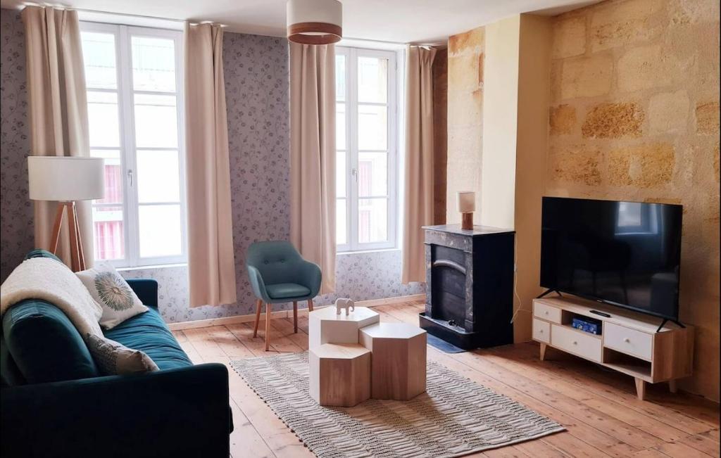 a living room with a couch and a flat screen tv at 4- Hypercentre, FREE Parking, Clim, Wifi, Netflix in Libourne