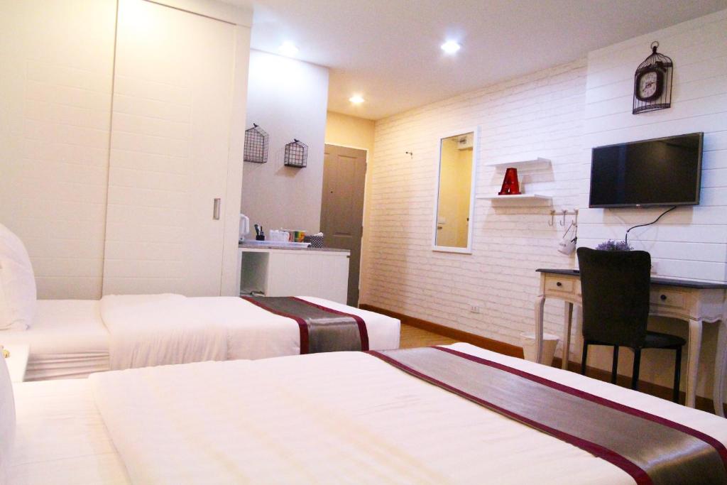 Postel nebo postele na pokoji v ubytování At Residence Suvarnabhumi Hotel