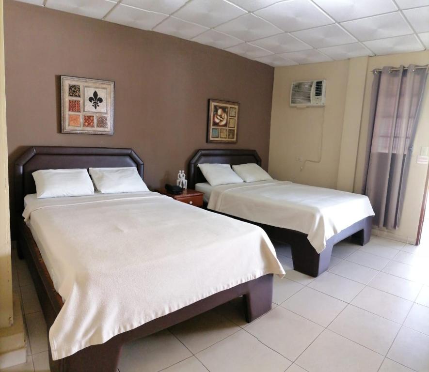 Postel nebo postele na pokoji v ubytování Residencial Tropical