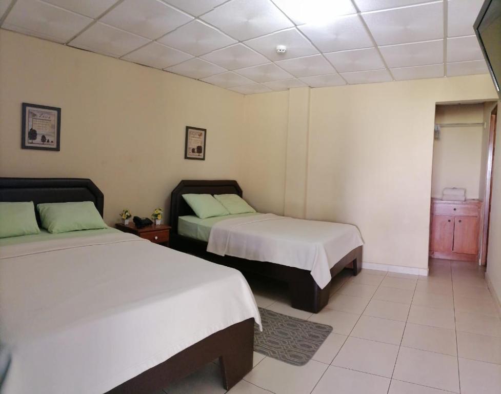 Postel nebo postele na pokoji v ubytování Residencial Tropical