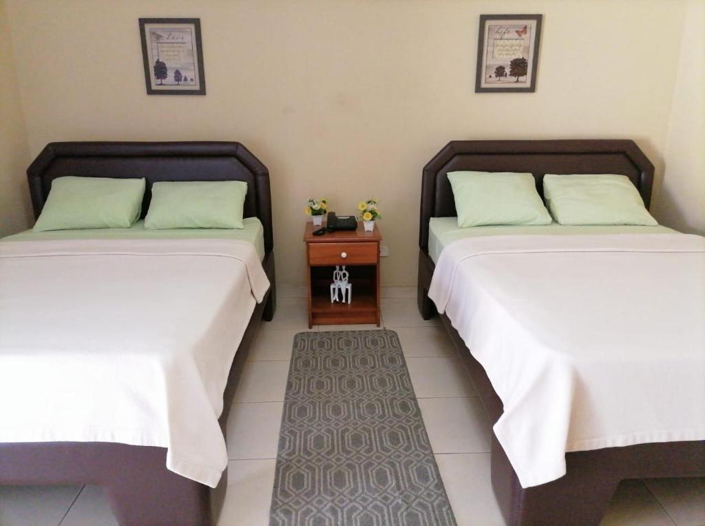 Postel nebo postele na pokoji v ubytování Residencial Tropical