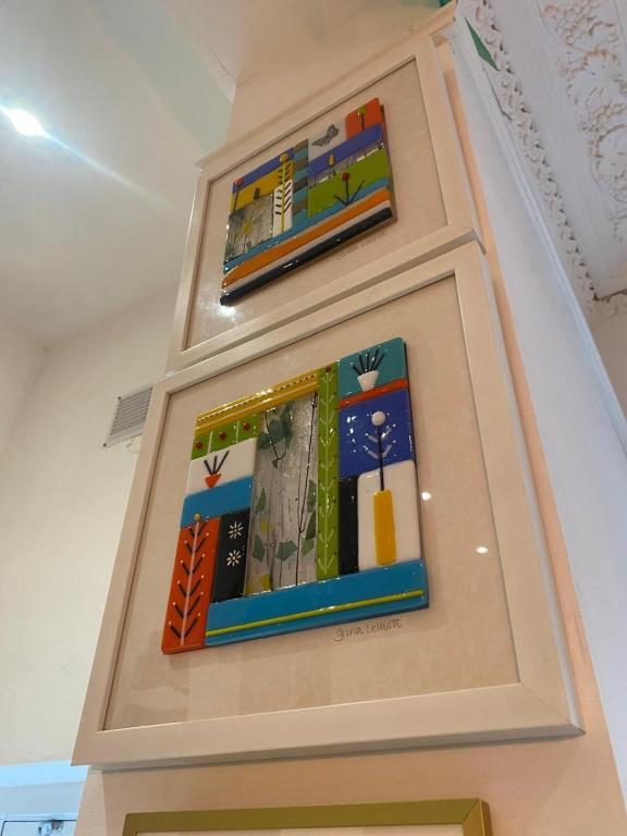 a framed picture of books on a wall at Church Retreat - A Magnificent Seaside Apartment-Award Winning in Hastings