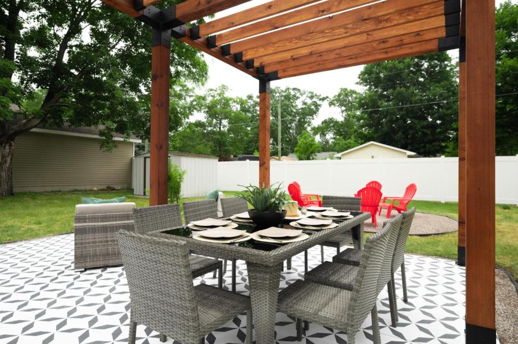 a patio with a table and chairs under a pergola at Bohemian Retreat in Traverse City