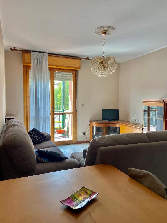 a living room with a couch and a table at Casa Flora in Ivrea