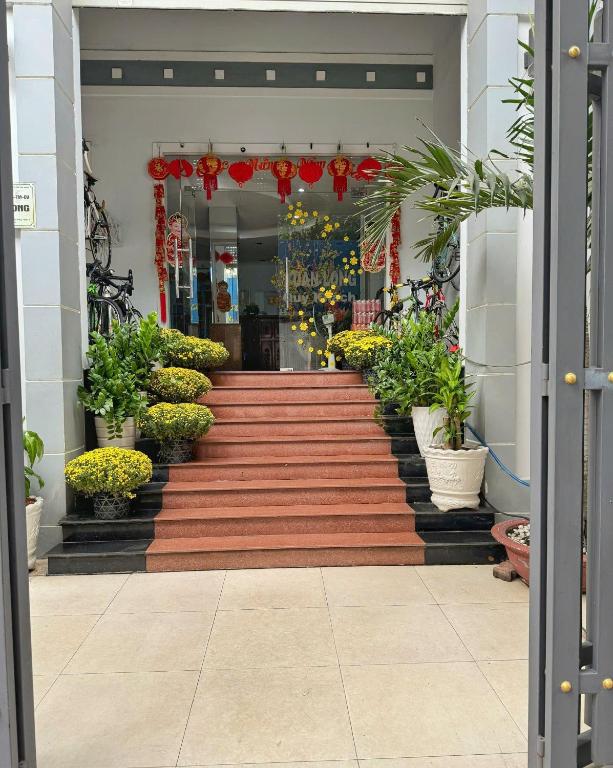 a set of stairs with potted plants in a building at Tuan Long Hotel in Ho Chi Minh City