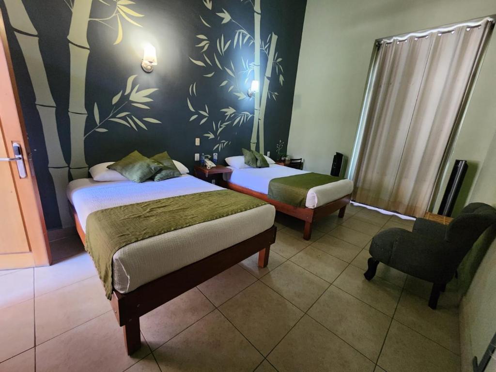 Postel nebo postele na pokoji v ubytování Hotel Plaza Queretaro