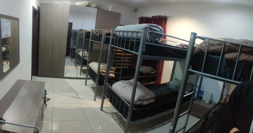 a group of bunk beds in a room with a mirror at Girls Only Shared Room Gzira #2 in Il-Gżira