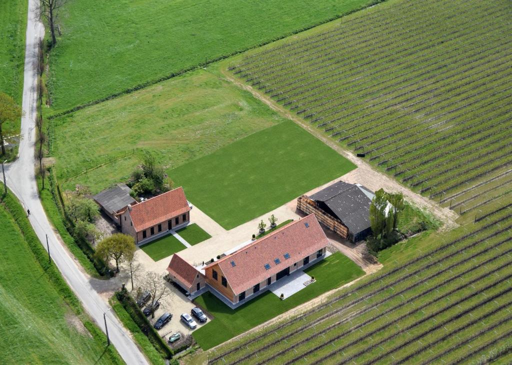 an aerial view of a house in a field at Vakantiehoeve Berckelaer in Sint-Gillis-Waas