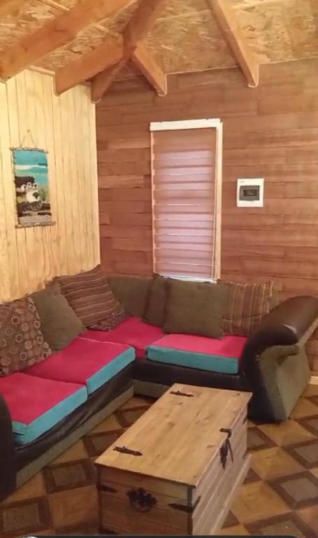 a living room with a couch and a table at Patagon karim in Puerto Cahacabuco