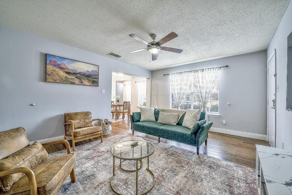 a living room with a couch and a table at Centrally Located DFW Retreat in Irving
