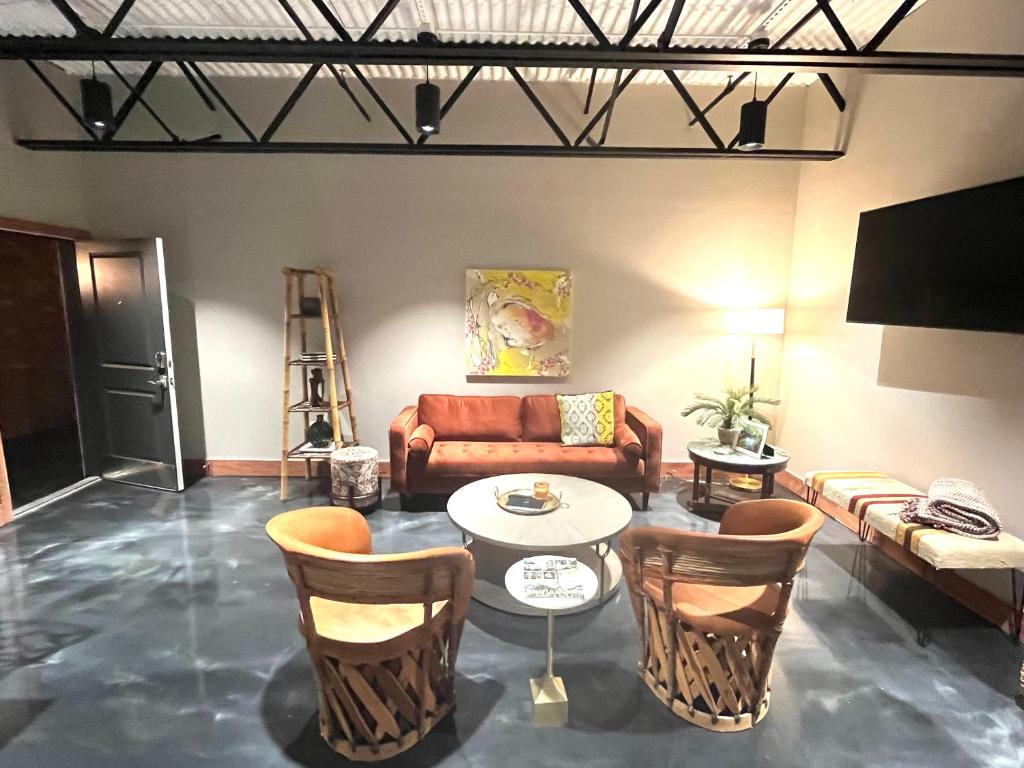 a living room with a couch and a table and chairs at The Secret Cenote Hotel in Jacksonville