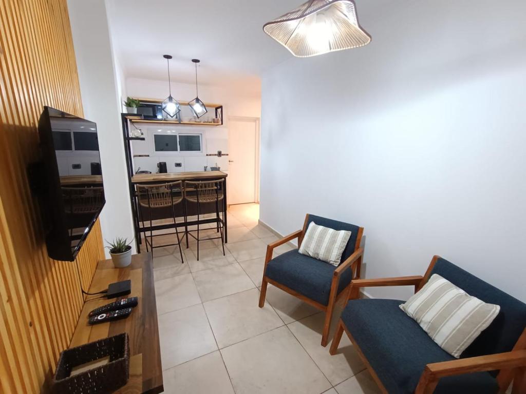 a living room with a couch and chairs and a kitchen at Lagom Apart 1 in Posadas
