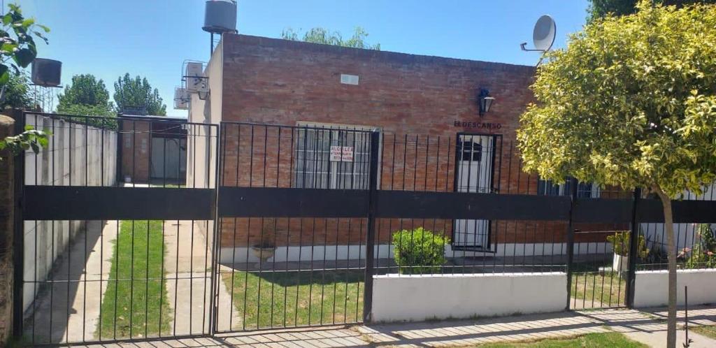 una cerca negra frente a un edificio de ladrillo en Don cholo, en Buenos Aires