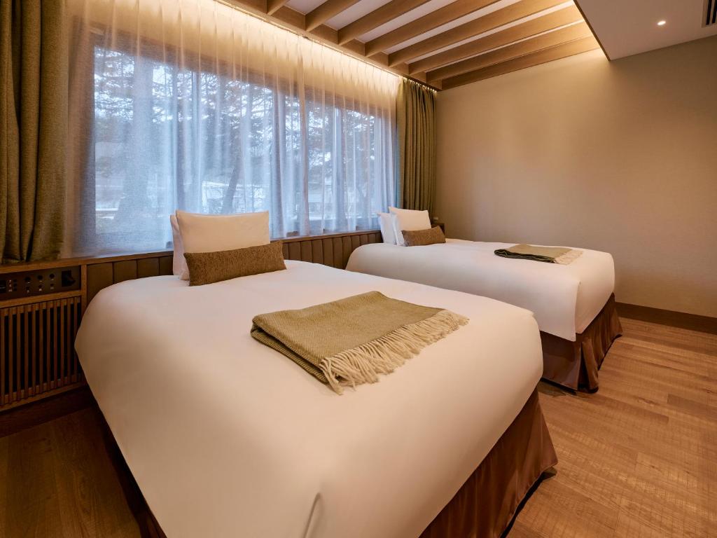 Postel nebo postele na pokoji v ubytování Glamdy style hotel suite 山ノ麓