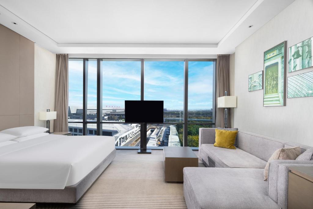 a hotel room with a bed and a large window at Hyatt House Shanghai Hongqiao CBD in Shanghai