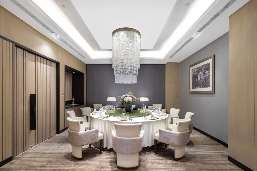 a large dining room with a white table and chairs at Hyatt House Shanghai Hongqiao CBD in Shanghai