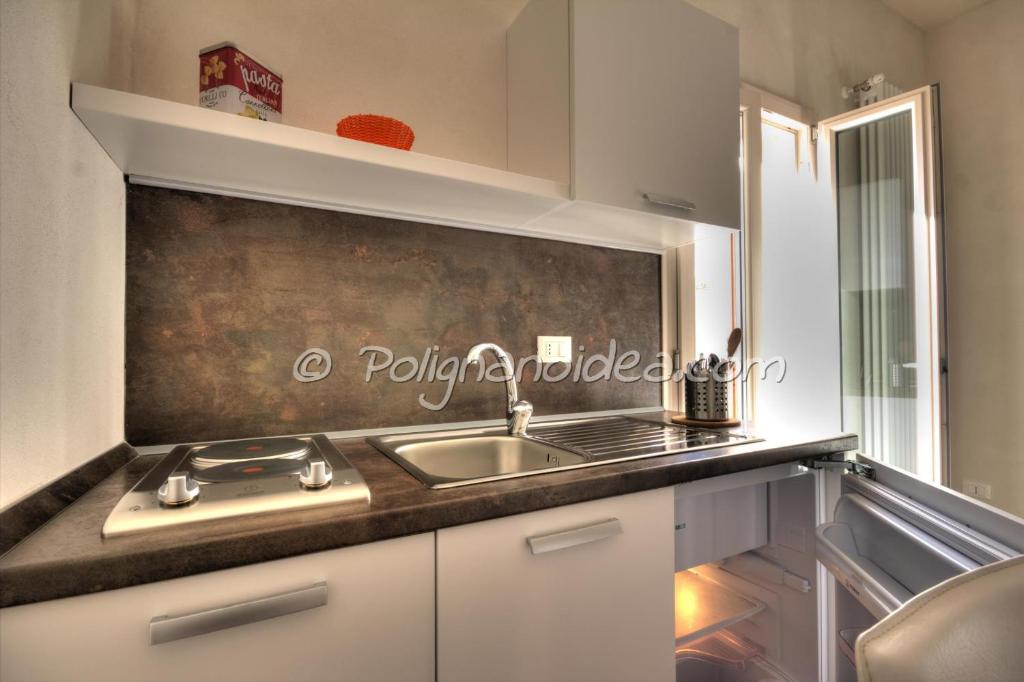 a kitchen with a sink and a counter top at B&b Monopoli Old Town in Monopoli