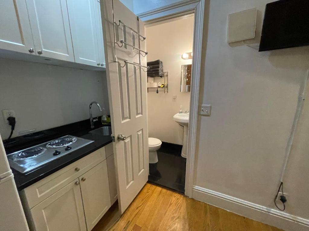 a small bathroom with a sink and a toilet at Nestel Nest 1 bedroom apartment in New York