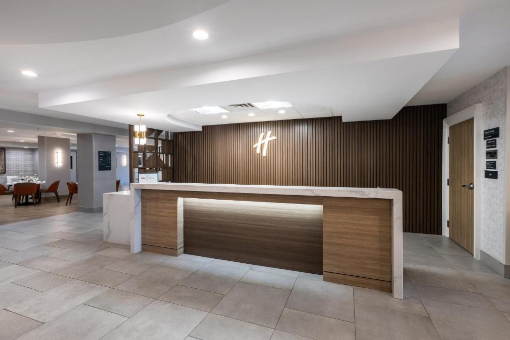 a lobby of a hospital with a reception desk at Holiday Inn Anderson by IHG in Anderson