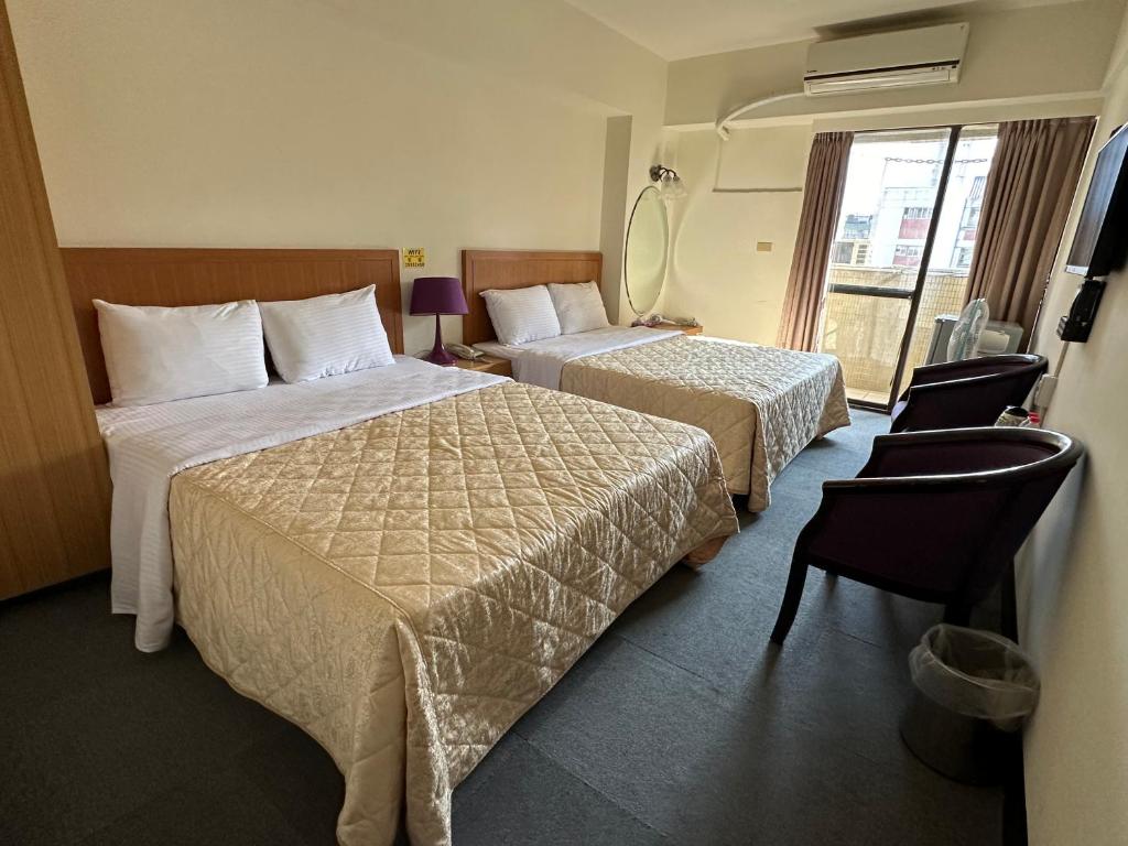 Postel nebo postele na pokoji v ubytování Chian Huei Business Hotel