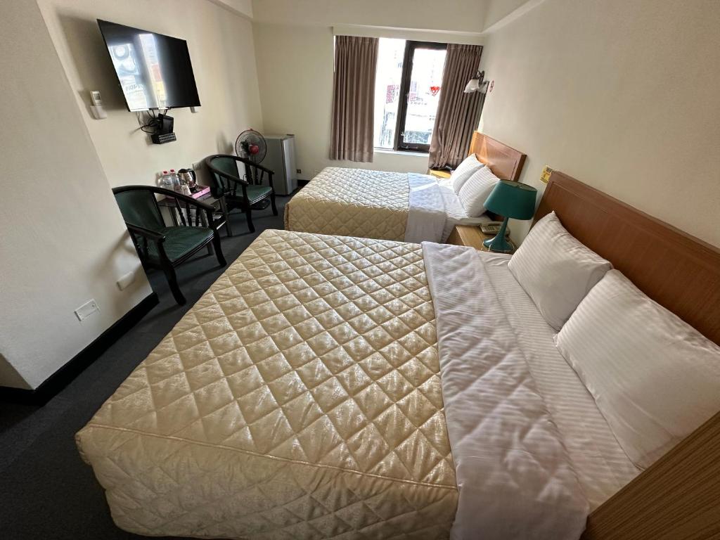 Postel nebo postele na pokoji v ubytování Chian Huei Business Hotel