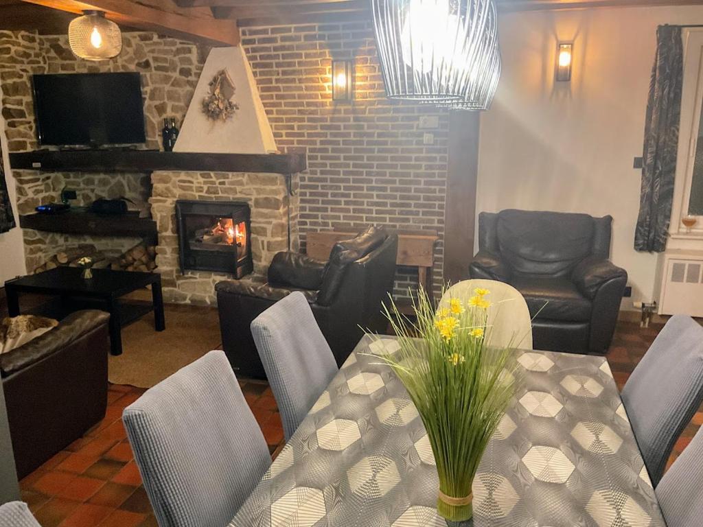 un salon avec une table et une cheminée dans l'établissement Le Refuge du Grand Mitan, à IsiÃ¨res