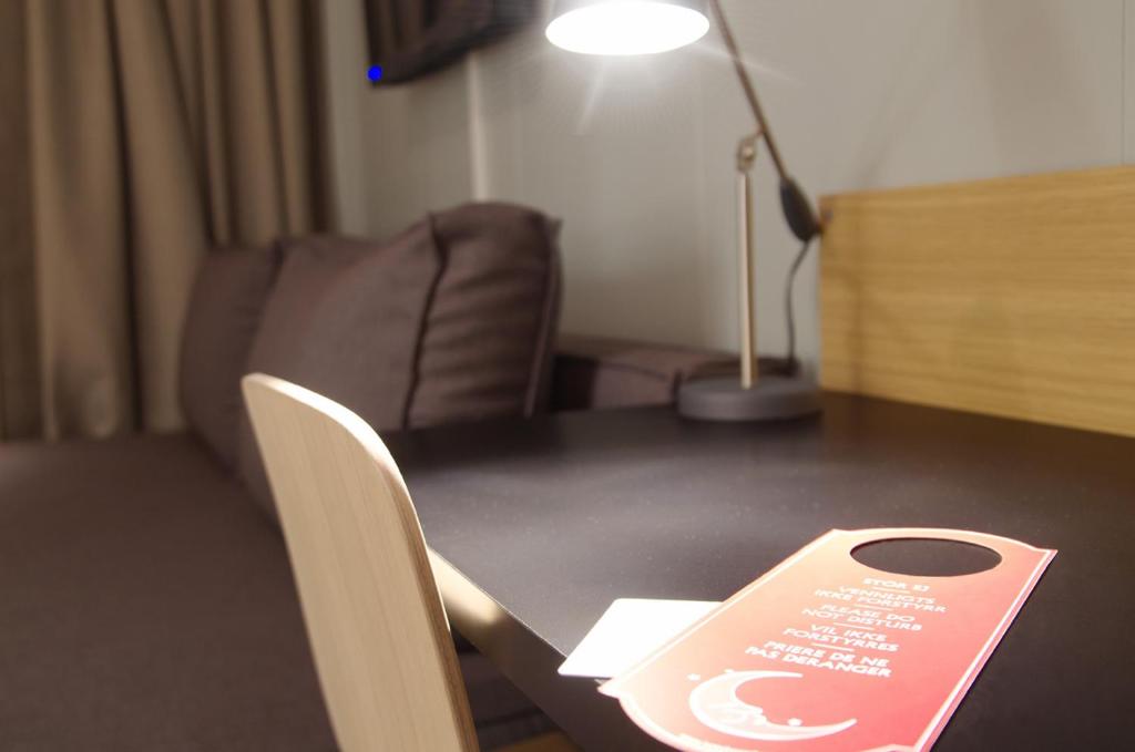 a table with a sign sitting on top of it at Hamarøy Hotel in Innhavet