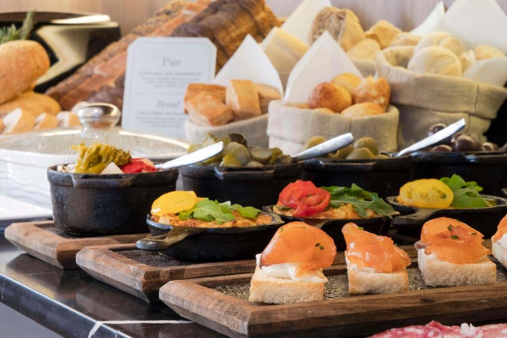 a buffet of different types of bread and pastries at NH Collection Buenos Aires Jousten in Buenos Aires