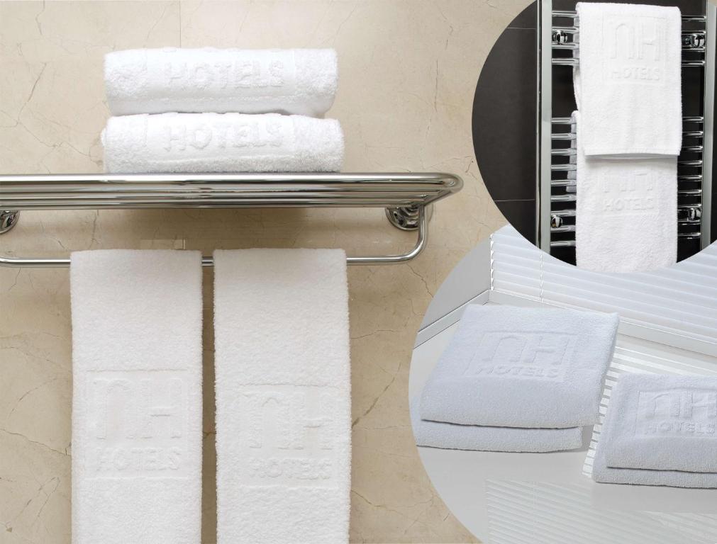 a pile of towels on a rack next to a mirror at NH Collection Buenos Aires Jousten in Buenos Aires