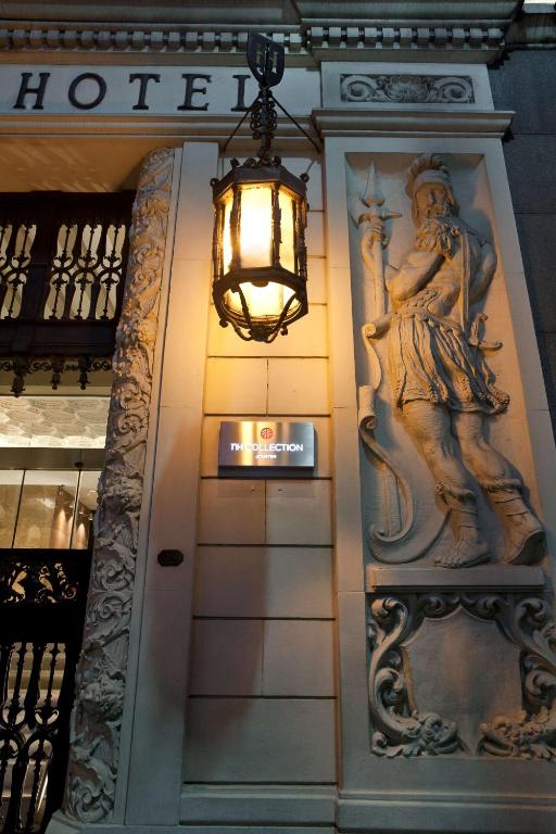 a building with a light and a statue on the wall at NH Collection Buenos Aires Jousten in Buenos Aires