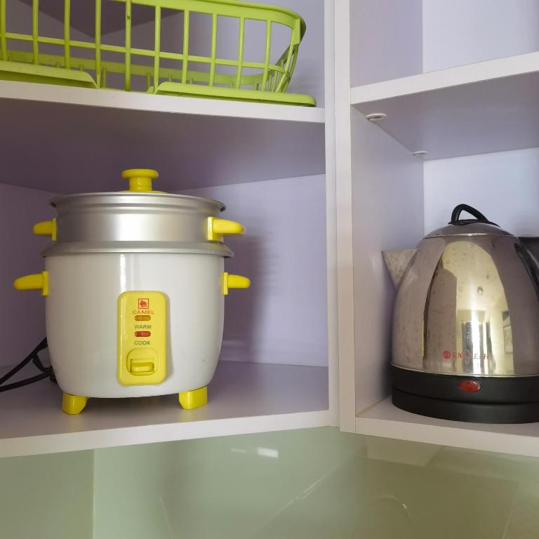 a kitchen with a pot and a toaster on a shelf at Avida Davao Condos, downtown CM Recto Avenue, Davao City in Davao City
