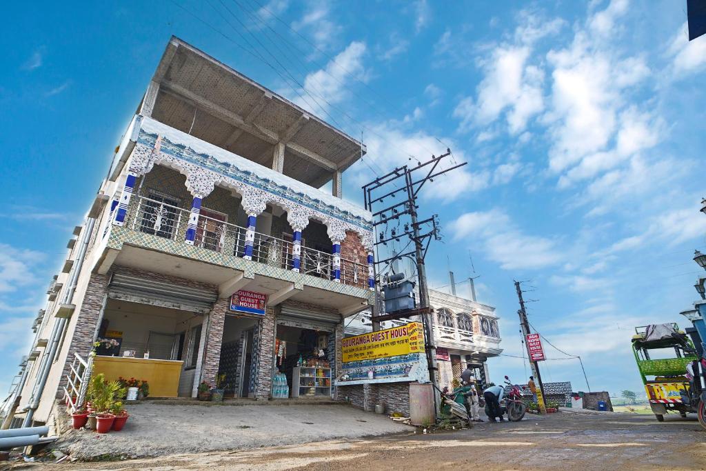 a building with a balcony on the side of it at Gouranga Guest House Mayapur ISKCON 300 MTS in mayapur