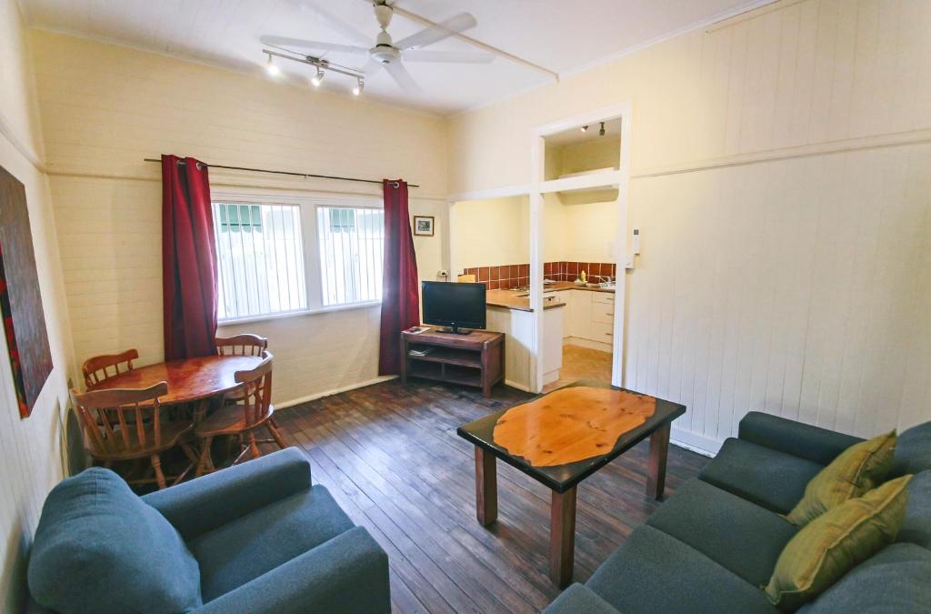 a living room with a couch and a table at Ryan's Rest Boutique Accommodation in Cairns