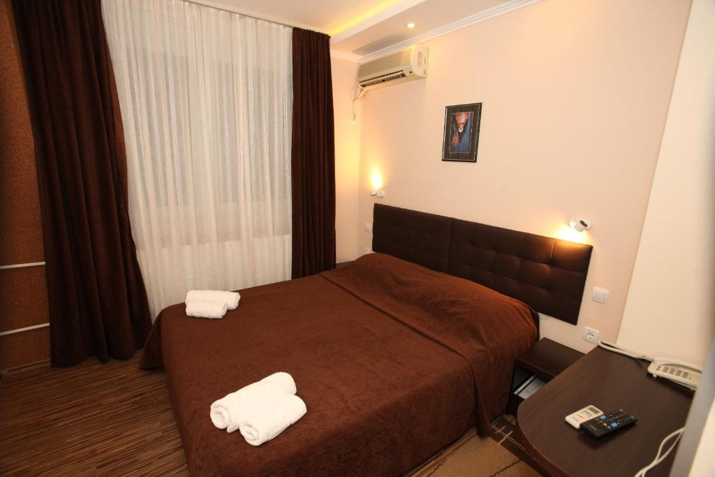 Postel nebo postele na pokoji v ubytování Hotel Petrus