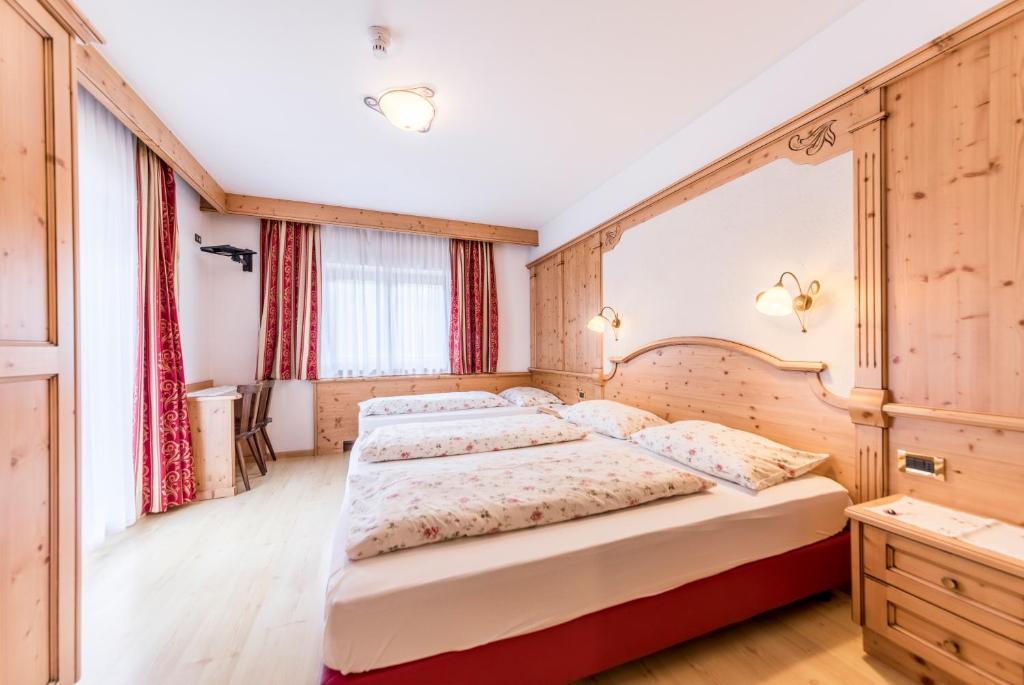 Postel nebo postele na pokoji v ubytování Garni Hotel Residence Diamant