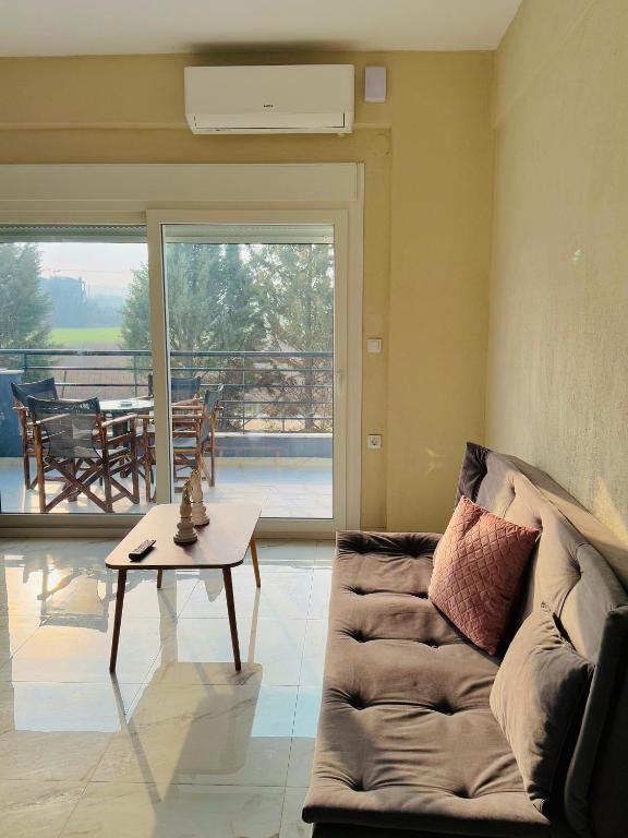 a living room with a couch and a table at Villa Athina 2 in Serres