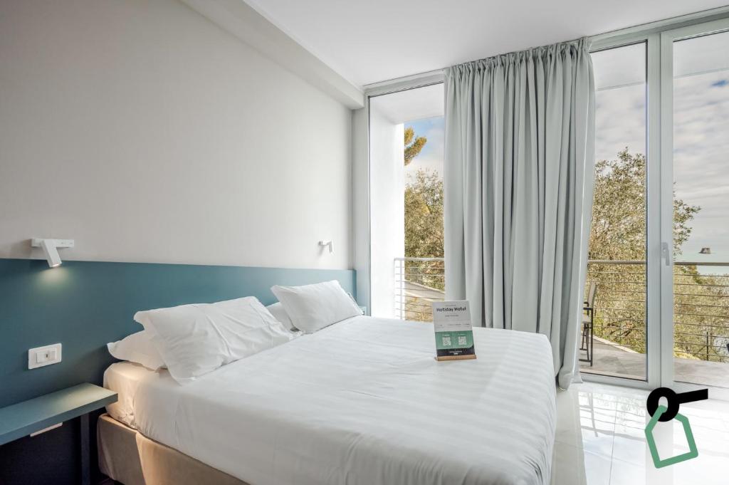 Postel nebo postele na pokoji v ubytování HOTIDAY Room Collection - Porto Venere