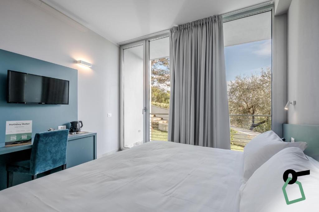 Postel nebo postele na pokoji v ubytování HOTIDAY Room Collection - Porto Venere