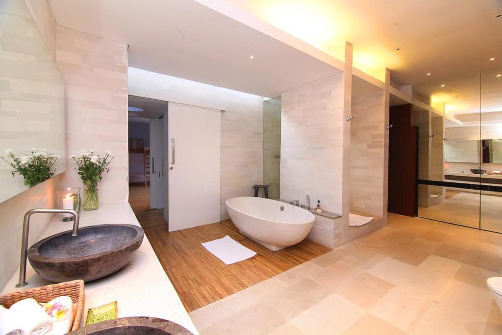 a large bathroom with a large tub and a sink at Large Private Villa, central Seminyak, Bali in Seminyak