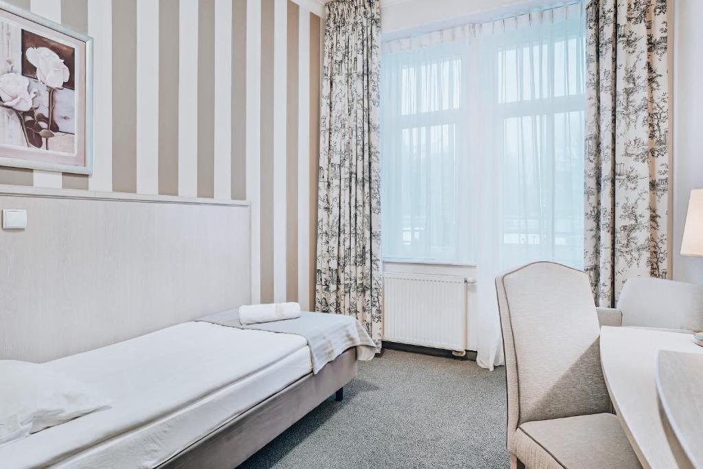 Postel nebo postele na pokoji v ubytování Hotel Amalia